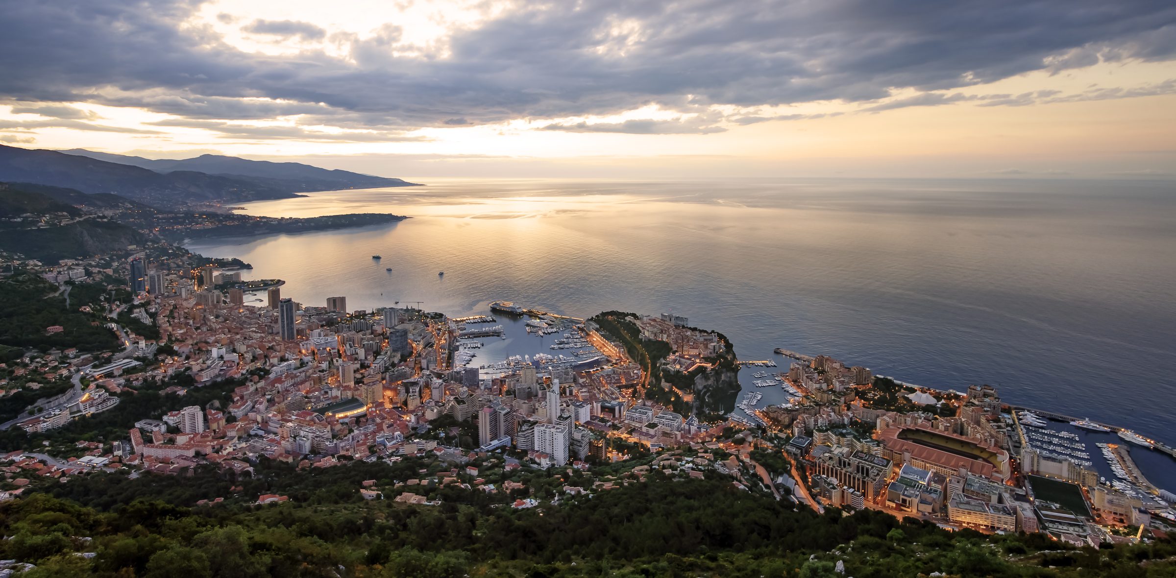 Aerial view of Monaco and the French Riviera coastline at dusk